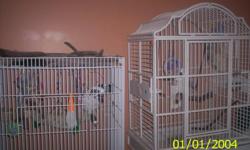 I have 2 extra large parrots cages, both white, both on wheels. They have large secure entry doors and feed cup doors. One has a playtop that can be removed, the other has an ornate top that opens up for a play area. They are about 5 and 6 feet tall, the